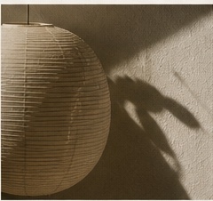 Sculptural table lamp against a textured wall